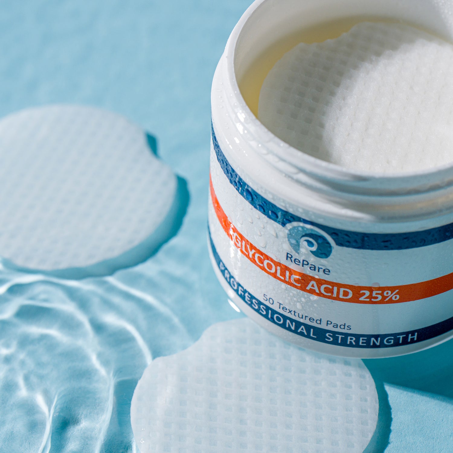 Jar of RePare Glycolic Acid 25% pads on a blue background